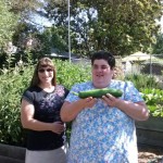 Katie and Ashley with the first veggie picked this season!